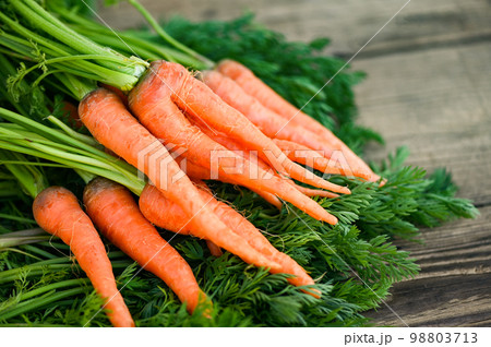 carrot on wooden table background, Fresh and sweet carrots for cooking food fruits and vegetables for health concept, baby carrots bunch and leaf carrot on wooden table background, Fresh and sweet carrots for cooking food fruits and vegetables for health concept, baby carrots bunch and leaf 98803713