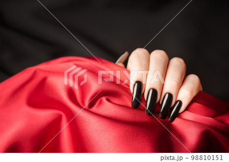 Hands of a young girl with black  manicure on nails 98810151