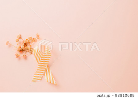 Pink awareness ribbon sign and paper card flower of World Cancer Day on pink background with copy space, concept of medical and health care support, Breast cancer awareness concept, 4 February 98810689