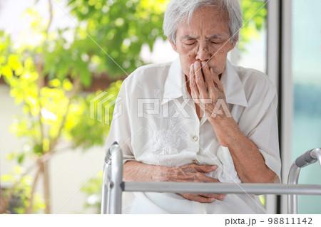 Asian senior woman with stomachache,old elderly holding her abdomen,covering mouth with hand,discomfort in the stomach associated with difficulty in digesting food,indigestion after eating fastfood Asian senior woman with stomachache,old elderly holding her abdomen,covering mouth with hand,discomfort in the stomach associated with difficulty in digesting food,indigestion after eating fastfood 98811142