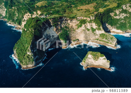 Coastline with scenic cliffs and ocean. Aerial view of scenic island Coastline with scenic cliffs and ocean. Aerial view of scenic island 98811389