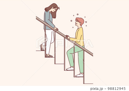 Woman with head down goes down stairs and man is waiting for beloved girlfriend Woman with head down goes down stairs and man is waiting for beloved girlfriend 98812945