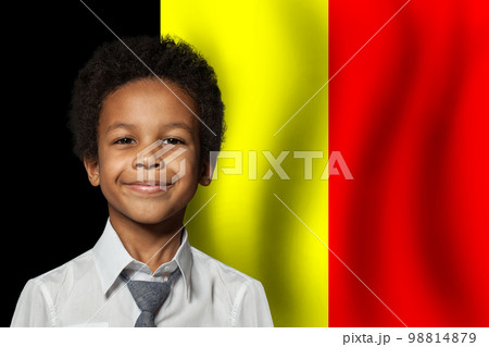 Belgium kid boy on flag of Belgium background. Education and childhood concept 98814879