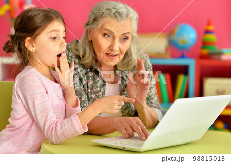 portrait of happy grandmother and daughter using laptop 98815013