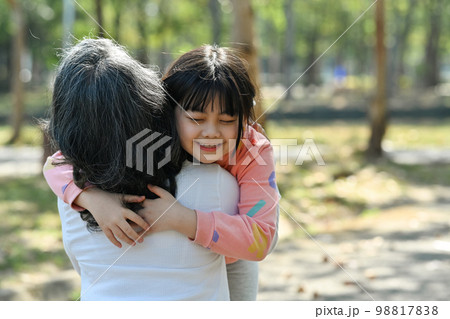 Affectionate little girl cuddling her mature grandmother. Loving family relationship and generational concept 98817838