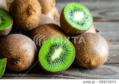 Ripe fruits of kiwi cut and whole, close -up. Ripe fruits of kiwi cut and whole, close -up. 98823643