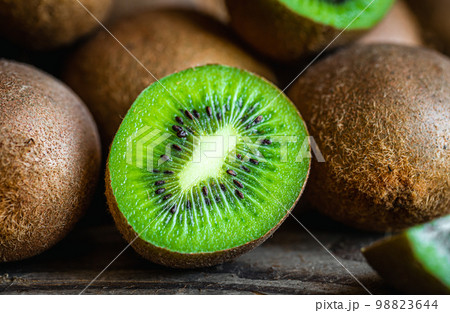 Ripe fruits of kiwi cut and whole, close -up. 98823644