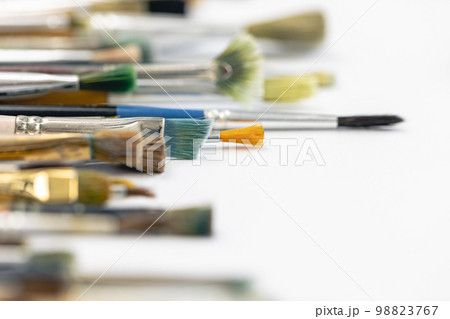 Paint brushes stained with paint, close-up, macro shot. Paint brushes stained with paint, close-up, macro shot. 98823767