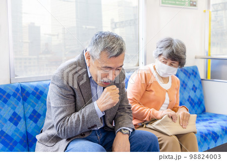 電車でマスクをする女性としない男性　コロナ規制緩和　倫理的ジレンマ 98824003