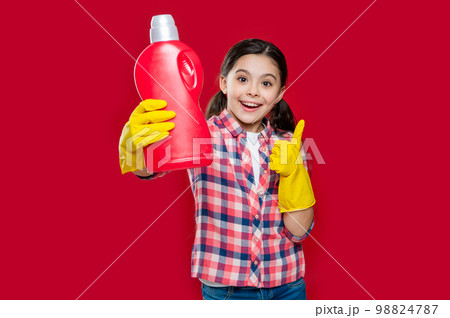 photo of girl household showing detergent. girl household with detergent isolated on red photo of girl household showing detergent. girl household with detergent isolated on red 98824787