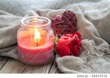 Valentine's day background with a candle and a rose close-up. 98825038