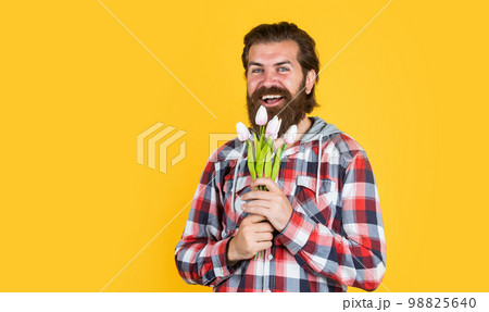 male hipster with fashionable groomed hair and beard hold tulip flowers, fathers day male hipster with fashionable groomed hair and beard hold tulip flowers, fathers day 98825640