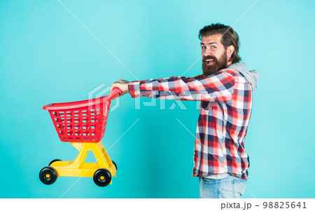 mature handsome man in checkered shirt carry shopping cart, purchase mature handsome man in checkered shirt carry shopping cart, purchase 98825641