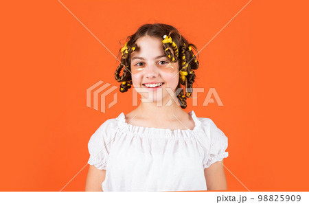 Teen hobbies. Hairstyling. Beautiful girl Curling Hair Using Curlers. Daughter with curlers on her head laughing. Hairdresser salon. Adorable child hairdo. Female beauty routine. Styling tips Teen hobbies. Hairstyling. Beautiful girl Curling Hair Using Curlers. Daughter with curlers on her head laughing. Hairdresser salon. Adorable child hairdo. Female beauty routine. Styling tips 98825909