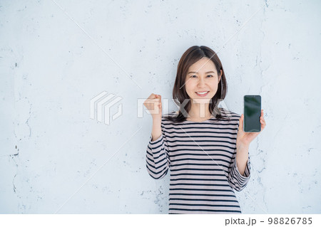 スマホを持ってガッツポーズをする女性 スマホを持ってガッツポーズをする女性 98826785