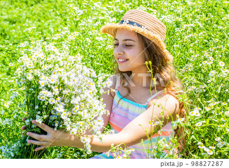 Girl harvesting flowering herbs sunny summer day, eco concept 98827287