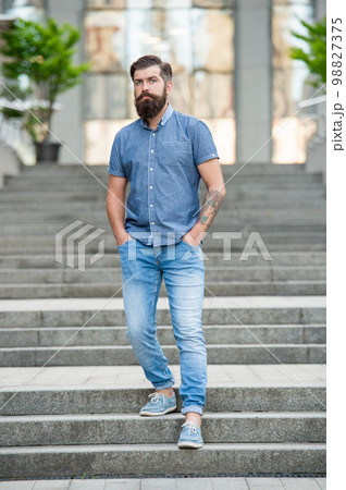 bearded man walk downstairs. full length of man with beard. caucasian man outdoor 98827375