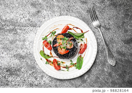 Delicious black risotto with seafood on grey table, flat lay 98828164