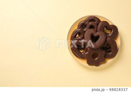 Concept of tasty bakery, gingerbread cookies in chocolate, space for text Concept of tasty bakery, gingerbread cookies in chocolate, space for text 98828337