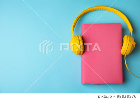 Book and headphones on light blue background, flat lay. Space for text Book and headphones on light blue background, flat lay. Space for text 98828576