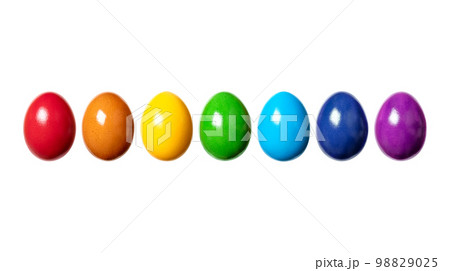 Rainbow, made of colorful dyed eggs, in a row. Hard boiled, multi colored chicken eggs, traditionally used during Easter time, as a gift, or for decoration. Front view close-up, isolated, macro photo. Rainbow, made of colorful dyed eggs, in a row. Hard boiled, multi colored chicken eggs, traditionally used during Easter time, as a gift, or for decoration. Front view close-up, isolated, macro photo. 98829025