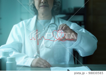 Cardiologist holding red heart in private clinic. Medical technology diagnostics of heart concept 98830565