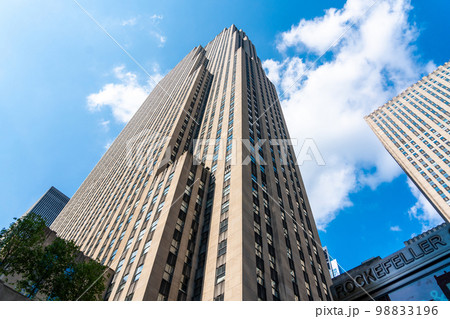 Rockefeller Center tower bottom view against blue sky in Manhattan in New York Rockefeller Center tower bottom view against blue sky in Manhattan in New York 98833196
