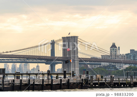 Spans of the Manhattan and Brooklyn bridges over the East River with Brooklyn in the background 98833200