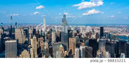 New York skyline, panoramic view with skyscrapers in Midtown Manhattan with blue sky New York skyline, panoramic view with skyscrapers in Midtown Manhattan with blue sky 98833221