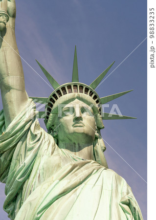 Close-up of the face and crown of the Statue of Liberty on a sunny day 98833235