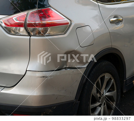 A dent on the rear fender and bumper of an SUV in its purest form as a common urban accident A dent on the rear fender and bumper of an SUV in its purest form as a common urban accident 98833297