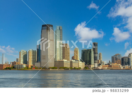 Cloudy sky over the skyscrapers of lower Manhattan from the opposite side of the East River Cloudy sky over the skyscrapers of lower Manhattan from the opposite side of the East River 98833299
