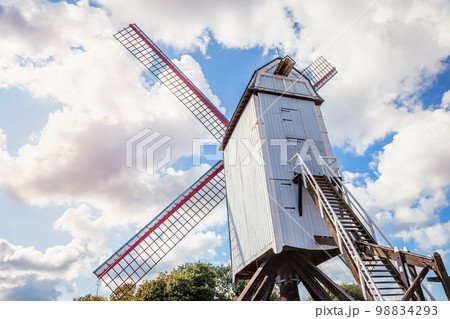 Rustic wooden windmill in idyllic Bruges public park, Belgium 98834293
