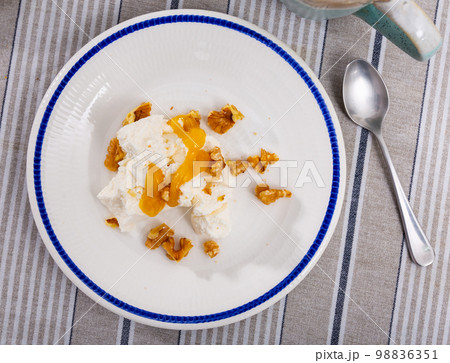 Mato served with honey and walnut on plate 98836351