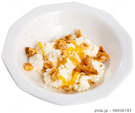 Catalan whey cheese, mato, served on plate with honey and walnuts Catalan whey cheese, mato, served on plate with honey and walnuts 98836785