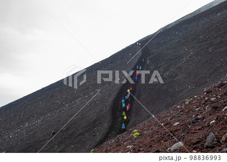 Mt Fuji trail between the 8th and 9th station on Fujiyoshida route with some people in the distance in Fujiyoshida, Yamanashi, Japan. August 4, 2022 Mt Fuji trail between the 8th and 9th station on Fujiyoshida route with some people in the distance in Fujiyoshida, Yamanashi, Japan. August 4, 2022 98836993