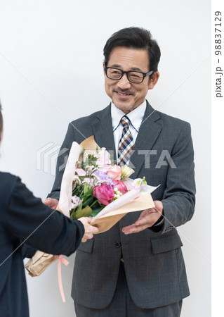 花束を受け取るミドルビジネスマン 98837129