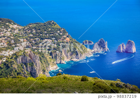 Above Capri city cliffs and Faraglioni with boats and yacht, amalfi coast, Italy 98837219