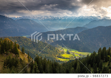 Bavarian alps and valleys from above at dramatic autumn sky, Garmisch, Germany Bavarian alps and valleys from above at dramatic autumn sky, Garmisch, Germany 98837273