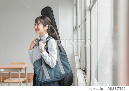 学校の教室で楽器・ギターを持った軽音部・吹奏楽部の高校生・中学生・女子高生（制服・バンド） 98837592