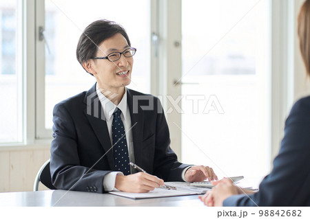 税金の相談を受けるアジア人男性税理士 98842682