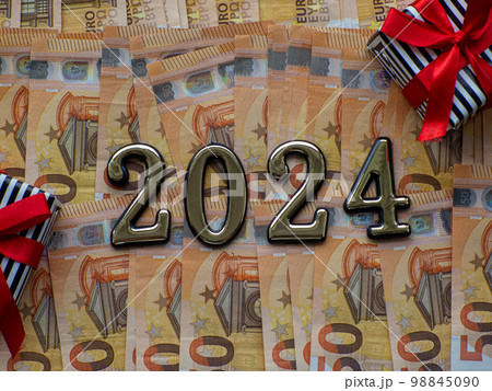 2024 and gift boxes on the background of fifty euros banknotes 98845090