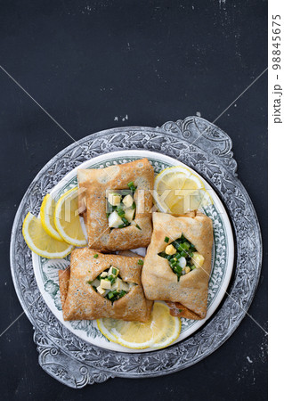 ruddy pancakes with fresh green onions and egg on a wooden background 98845675