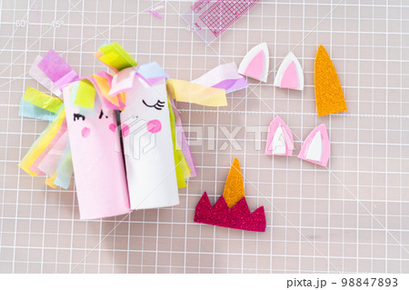 Flat lay. Making a unicorn out of the toilet paper roll and craft paper. 98847893
