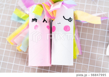 Flat lay. Making a unicorn out of the toilet paper roll and craft paper. 98847995