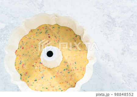 Cake batter in a bundt cake pan to bake funfettti bundt cake. Cake batter in a bundt cake pan to bake funfettti bundt cake. 98848552