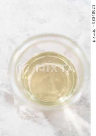 Freshly made simple syrup in a small glass jar. Freshly made simple syrup in a small glass jar. 98848621