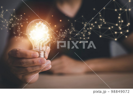 Innovative technology in science and communication concepts, and Creativity with glowing light bulbs.Hand hold light bulb with new idea concept with innovation, the new idea with energy and power 98849072