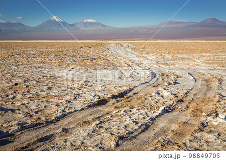 Dirt Road and licancabur a salt Valley dramatic landscape, Atacama Desert, Chile Dirt Road and licancabur a salt Valley dramatic landscape, Atacama Desert, Chile 98849705