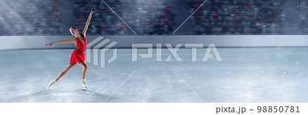 Beautiful girl in red dress, professional figure skater performing on dance competition, skating on 3D arena, ice rink. Graceful beauty 98850781